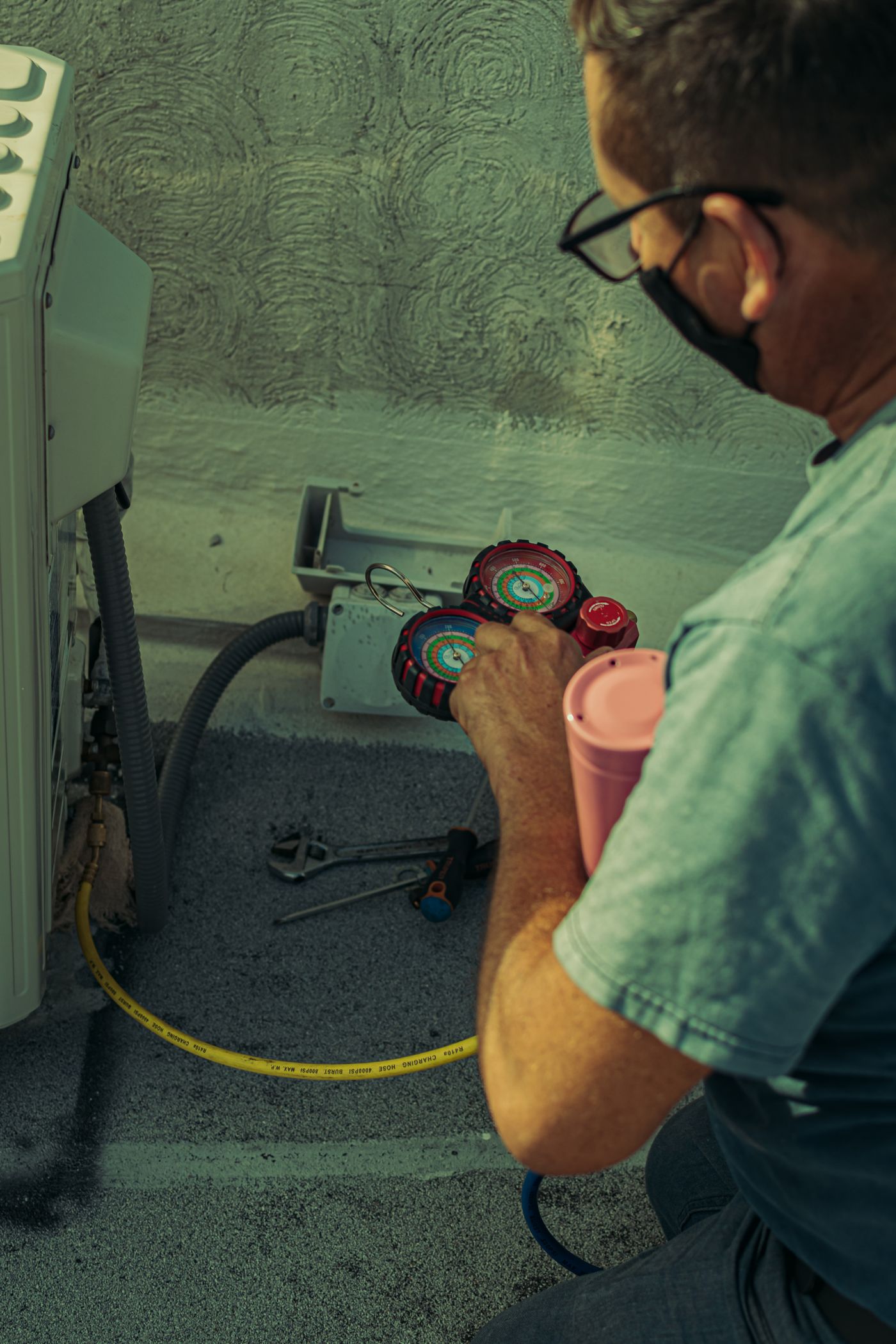 Technician replacing an outdoor HVAC system